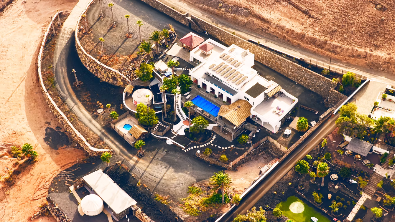 Hillside hotel with a pool cut into volcanic terrain