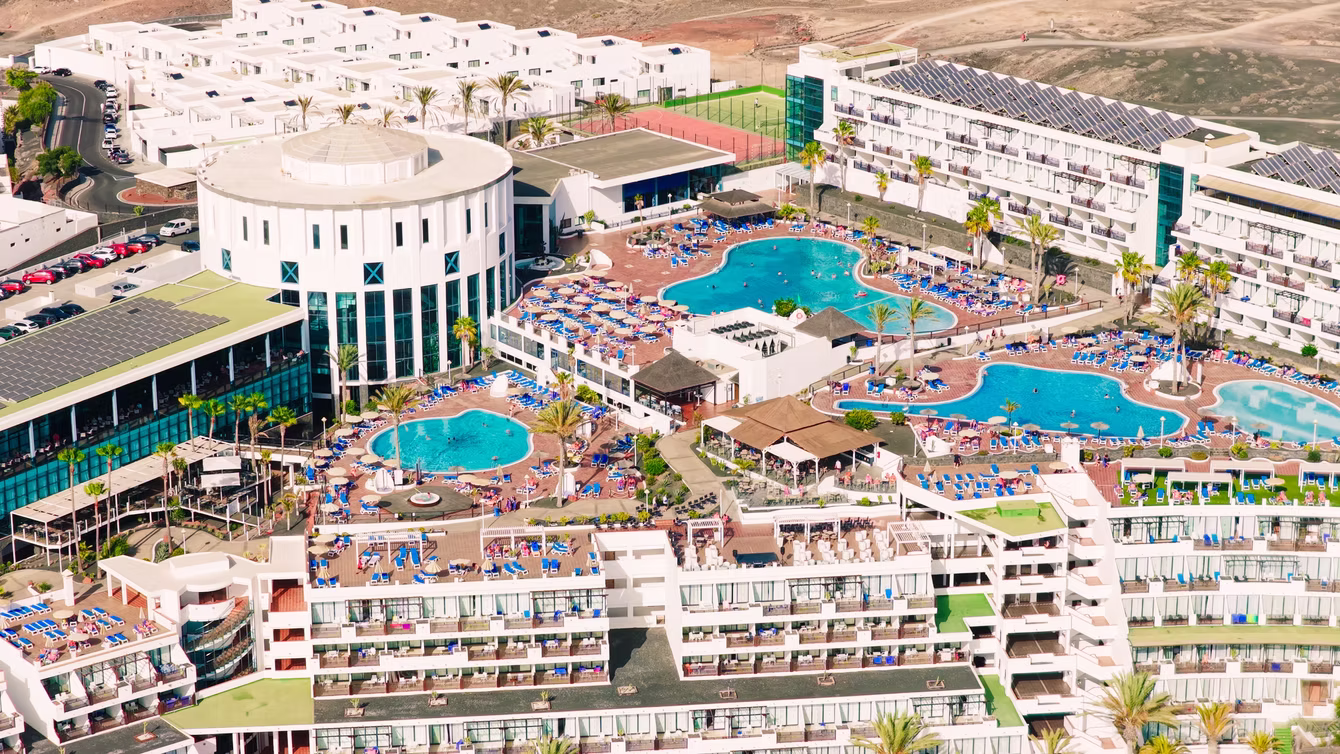 Aerial view of resort pools and white apartment blocks