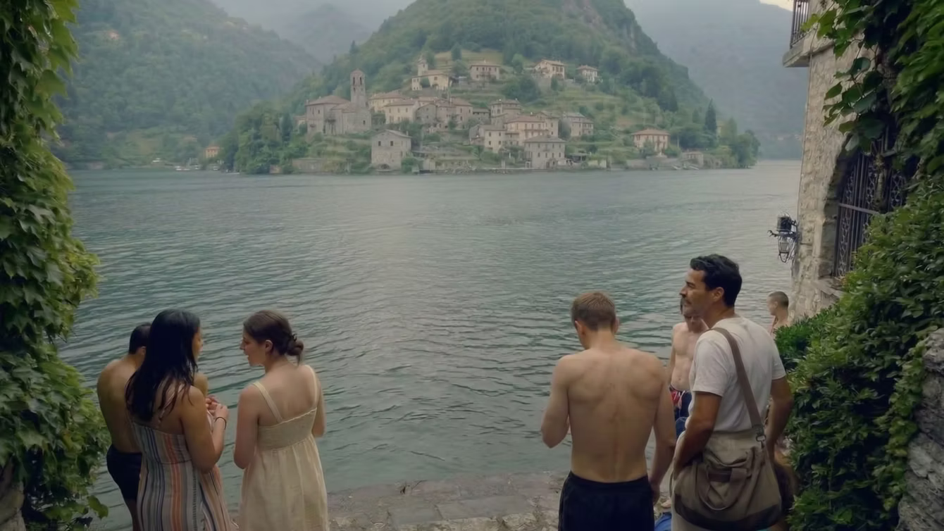 Visitors on a boardwalk looking across a lagoon to a rocky island