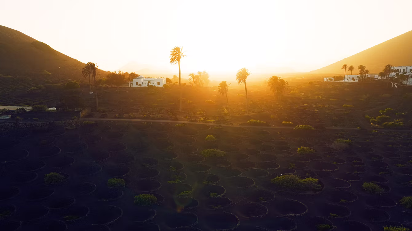 Sunrise breaking over a dark volcanic ridge
